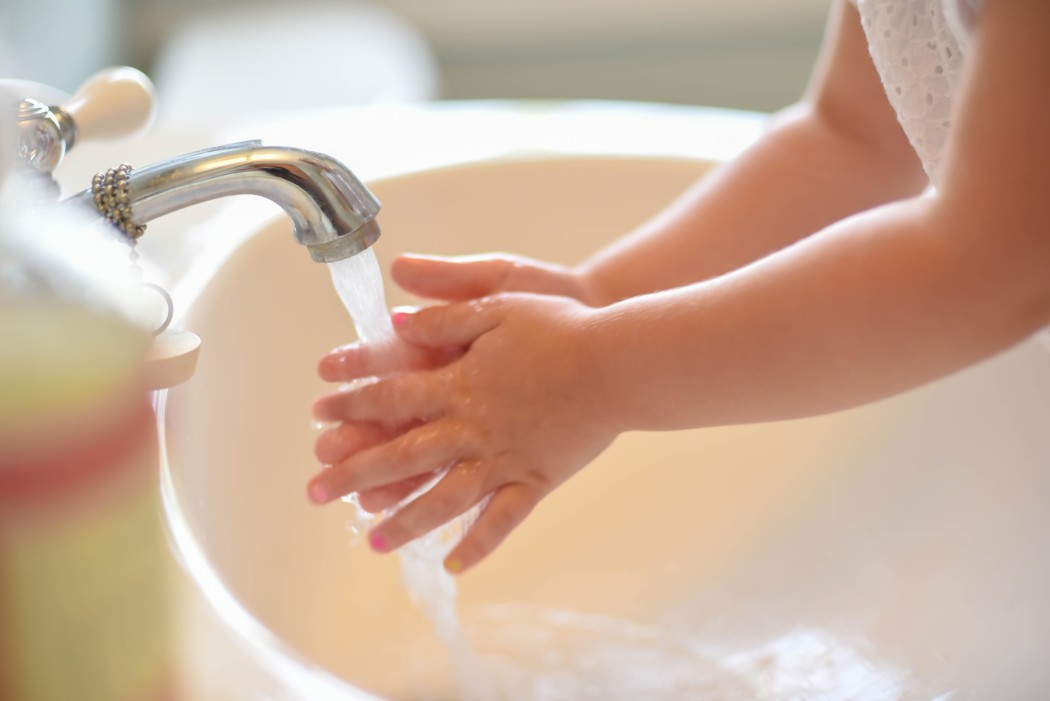 closeup-of-young-child-washing-hands-at-the-bathroom-sink-light-and-bright