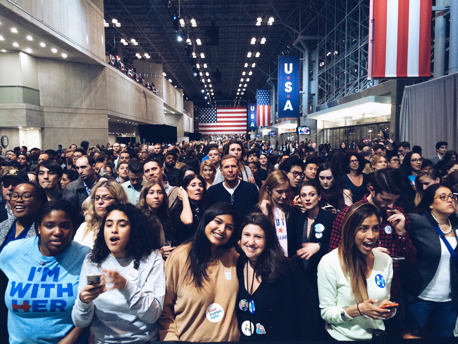 smiling crowd with voting stickers on