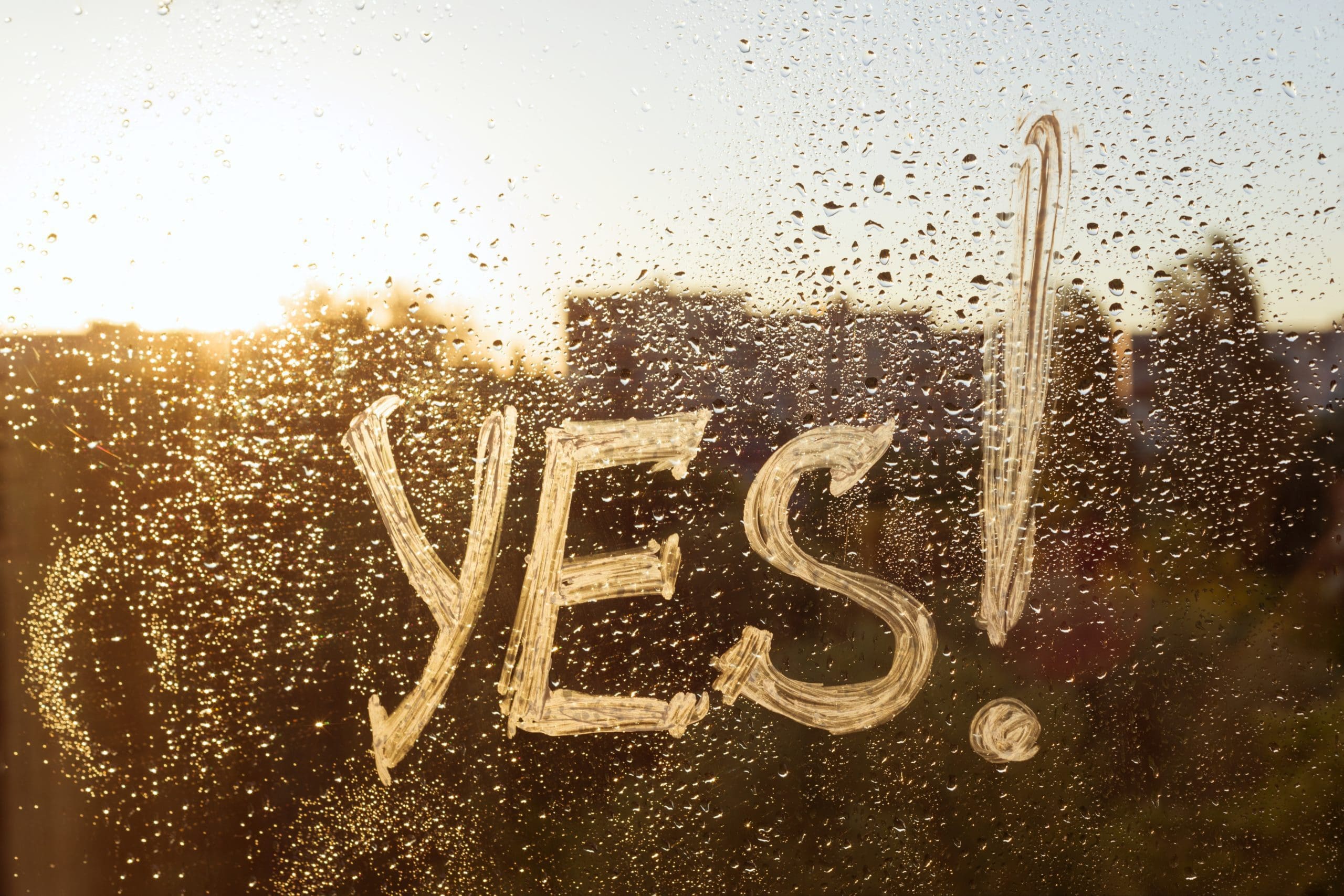 The Word "YES" drawn in the raindrops that formed on a window